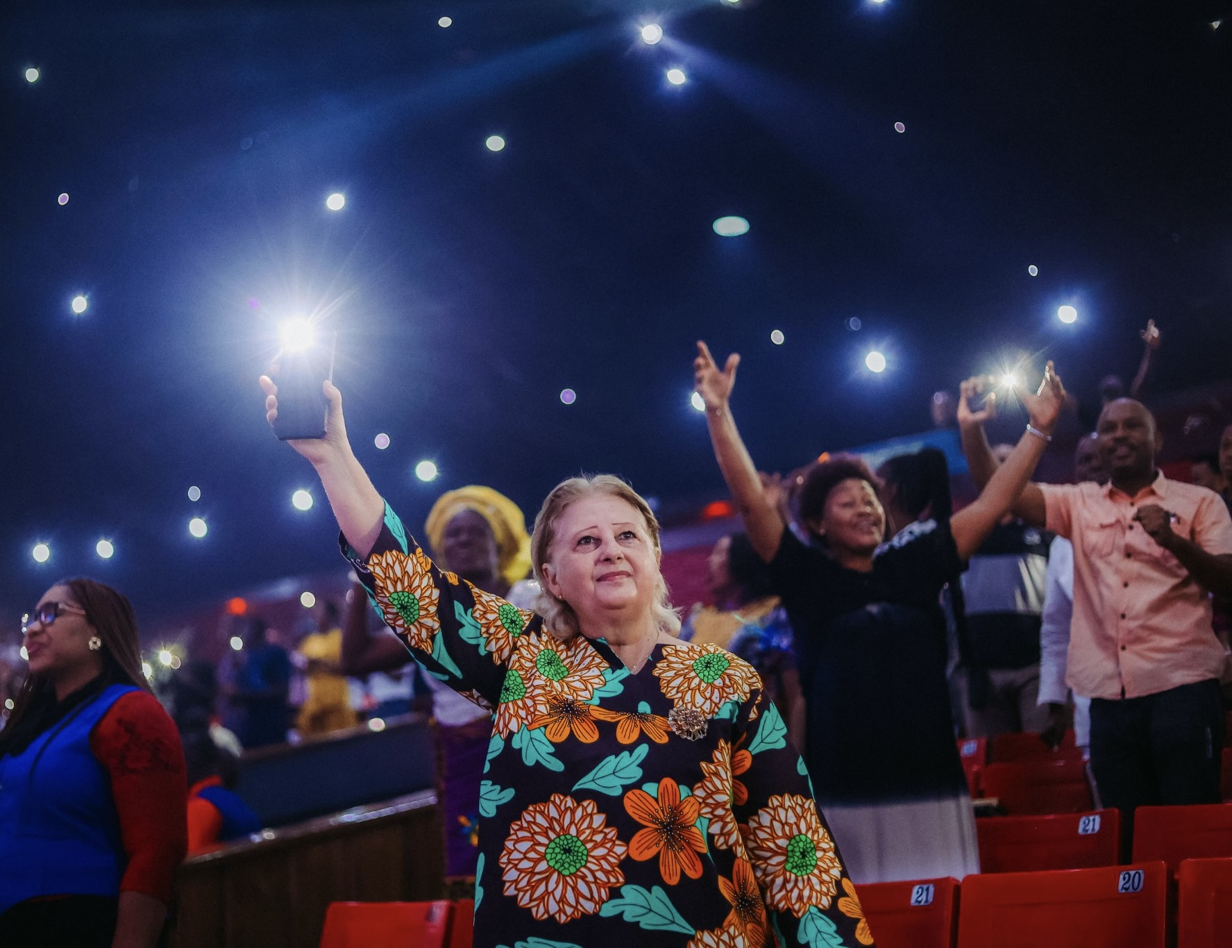 Congregation lifting lights in worship